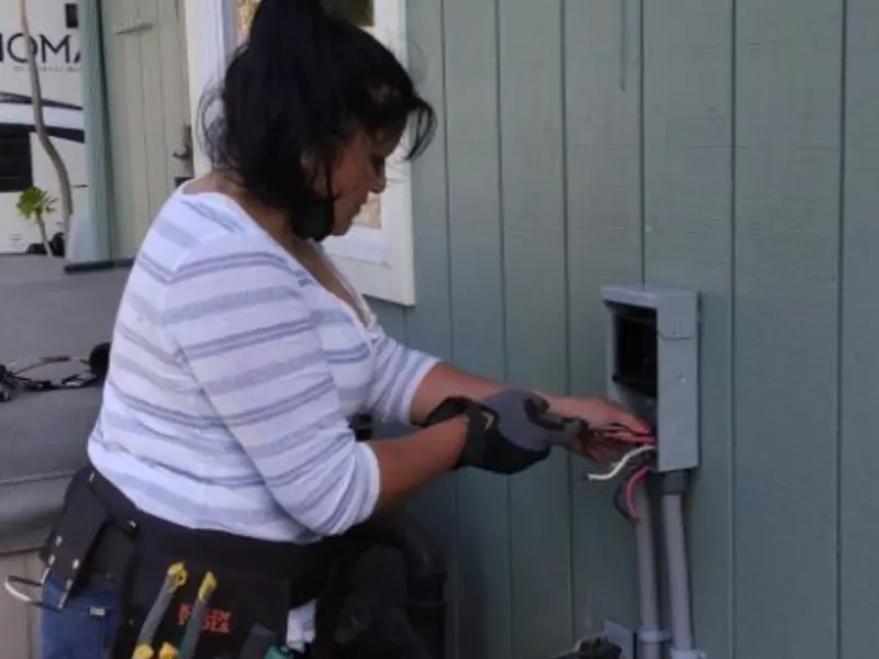 Licensed electrician wiring an exterior subpanel in Oconto Falls