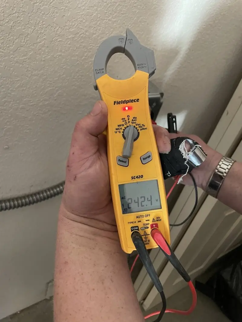 Voltage testing with clamp meter during Outlet Installation in Oconto Falls